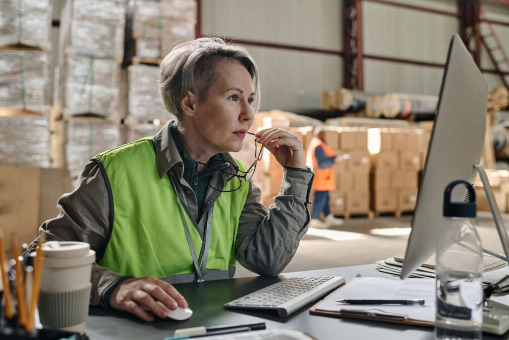 Account manager sourcing a new route for a customer on a computer.